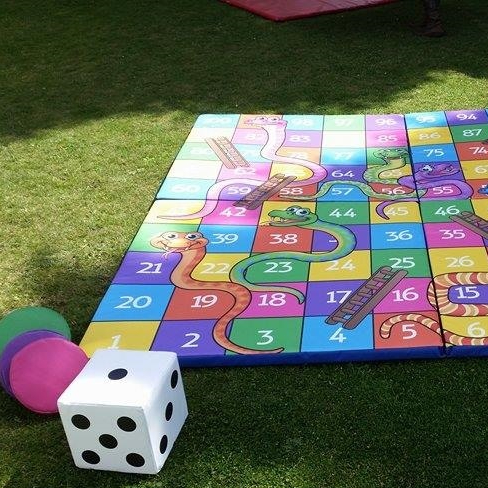 Giant boardgame of Snakes & Ladders set up nicely ready for a Family Garden event.