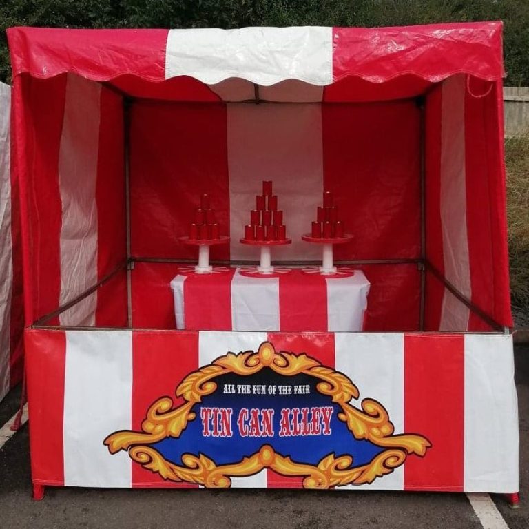 Our bright red and white striped Fete Game Side Stall set up with our Tin Can Alley game.