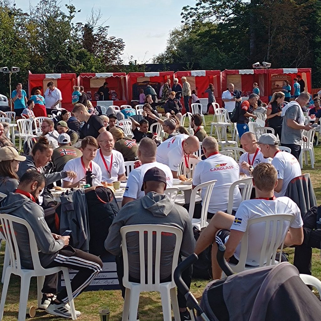 A huge crowd of people at a large village fete with 6 of our hired Fete Game Side Stalls towards the back.