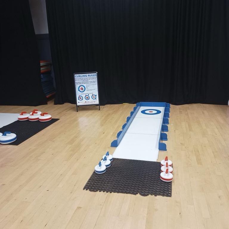 Child sized Curling Lane set up indoors ready for action.