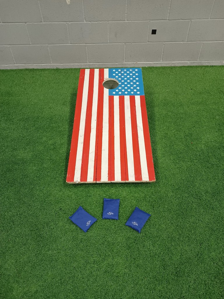 Our American Flag Cornhole Toss with beanbags hired and set up for an indoor event.