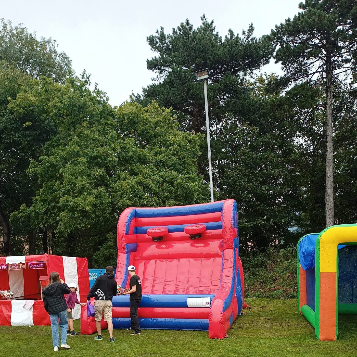 Group of teenagers about to play on the inflatable basketball at a college event