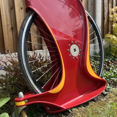 A wheel with its strong plastic surround which creates a platform for someone to stand and move the Unicycle Clown Bike.